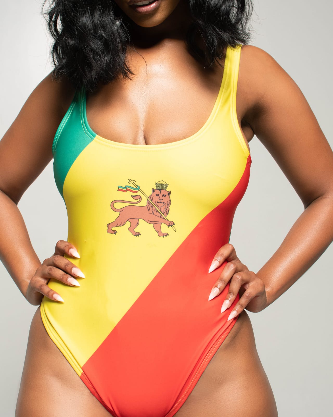 Front view of women's one-piece swimsuit inspired by the Ethiopia flag