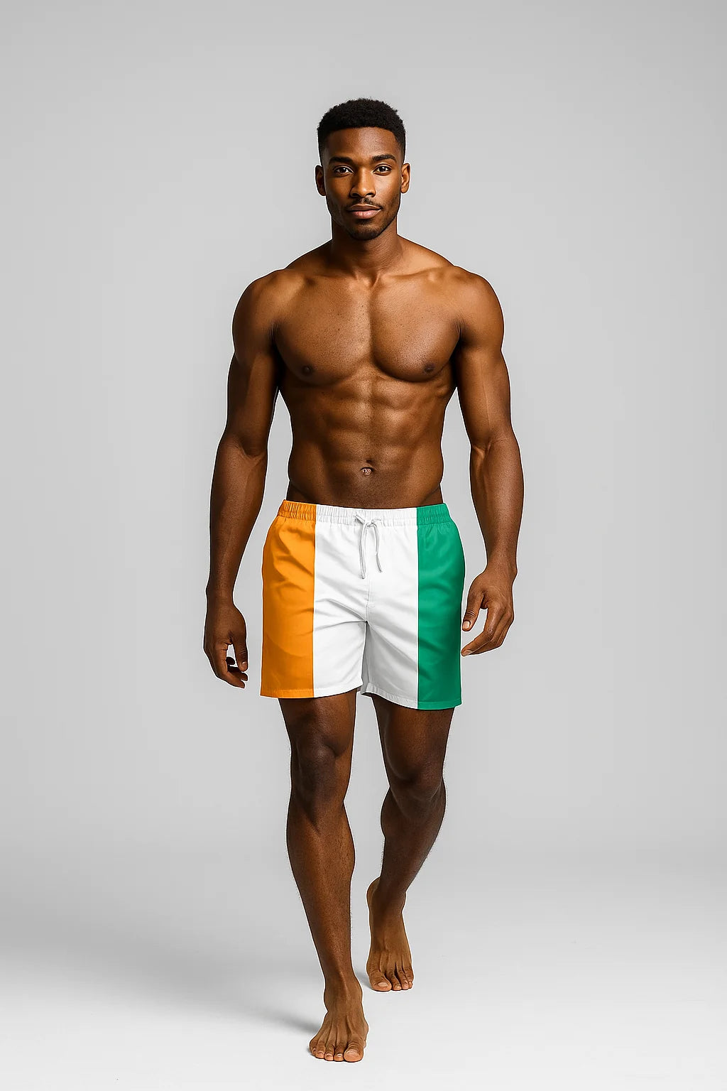 Studio view of male model in Ivory Coast flag swim shorts